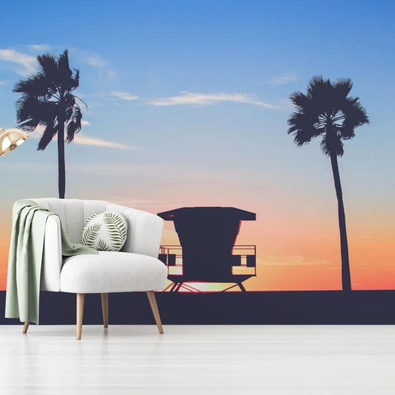 Fototapeta zachód słońca nad plażą z sylwetką wieży ratownika – Wallissimo®