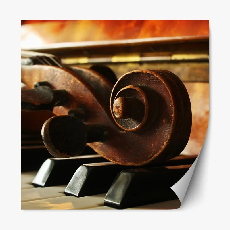 Naklejka repozycjonowalna zabytkowa główka skrzypiec na klawiszach fortepianu