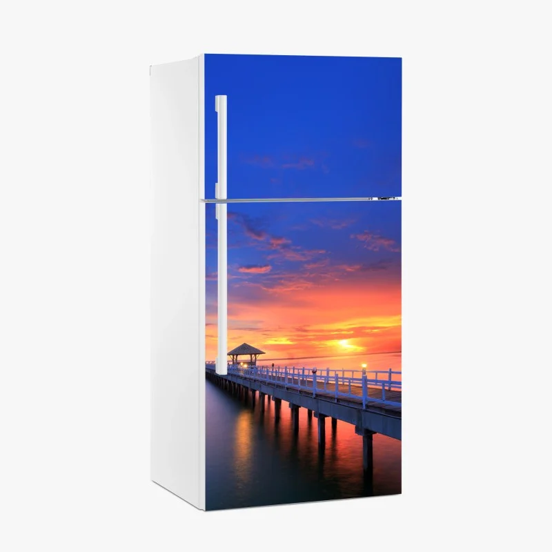 Naklejka na lodówkę molo o zachodzie słońca nad plażą