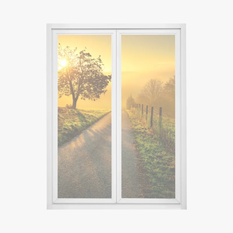 Naklejka na okno słoneczna droga przez wiejską łąkę o świcie