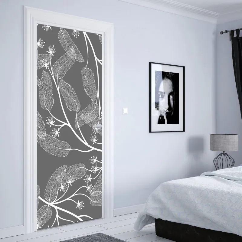 Naklejka na drzwi delikatne białe liście na szarym tle