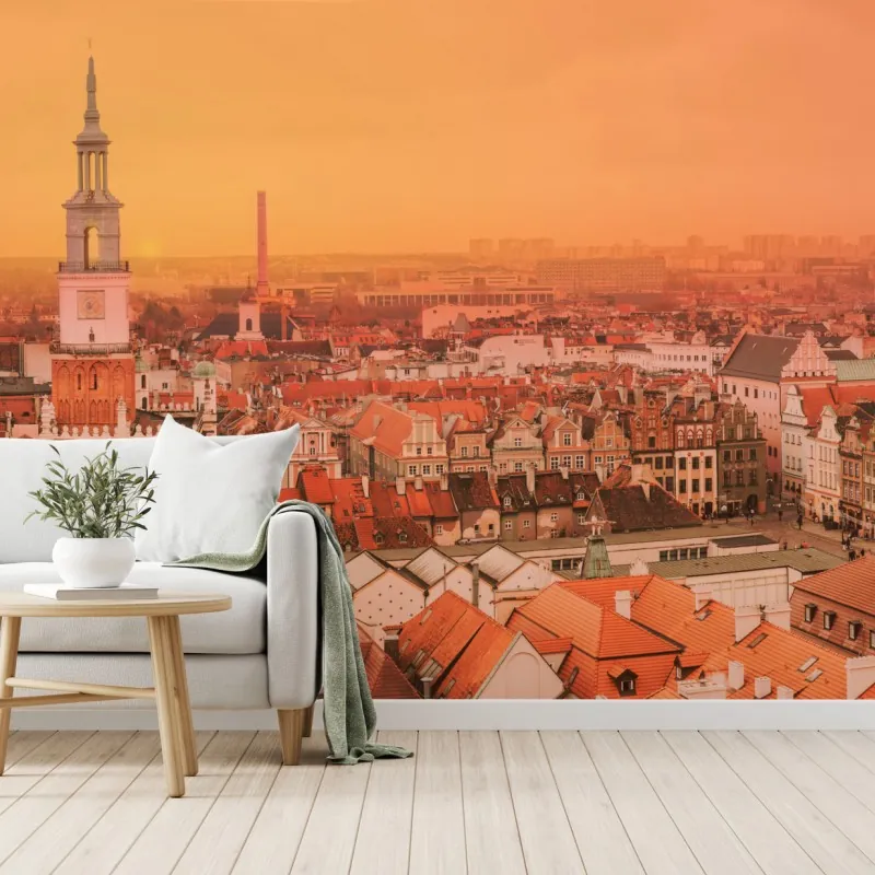 Fototapeta ciepły zachód słońca nad zabytkowymi dachami miasta