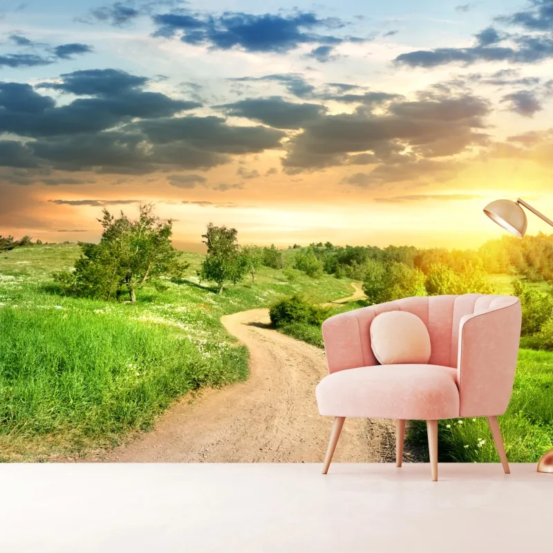 Fototapeta zachód słońca nad polną drogą w zielonej łące