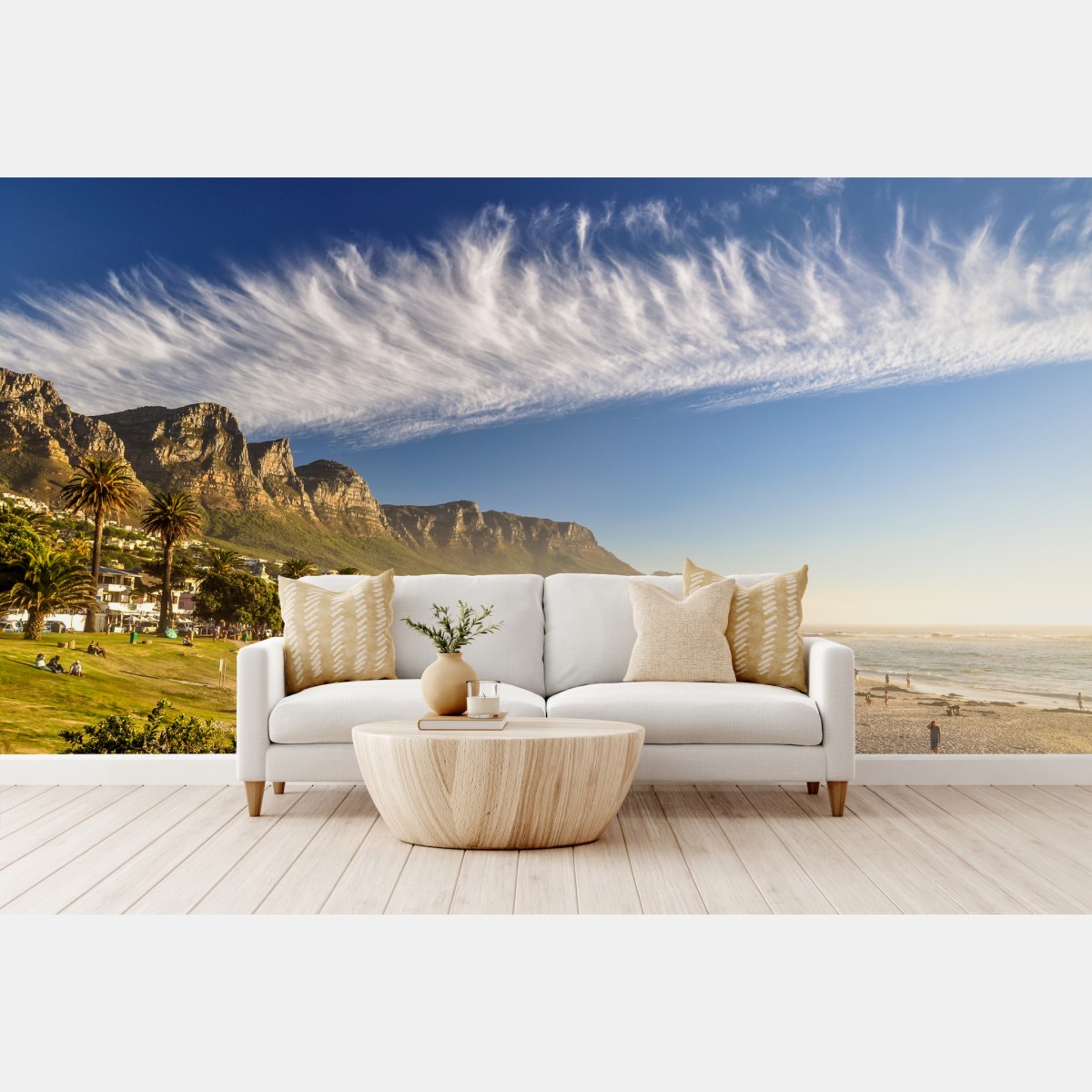 Wall mural sunlit beach with mountain backdrop