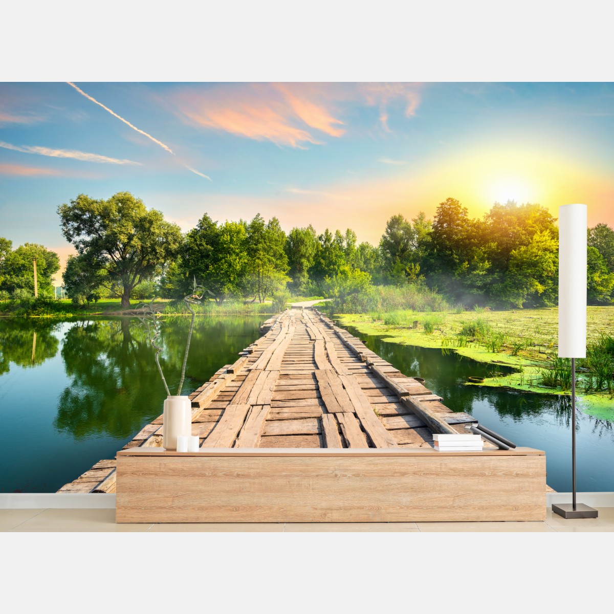 Wall mural sunlit wooden bridge over tranquil lake