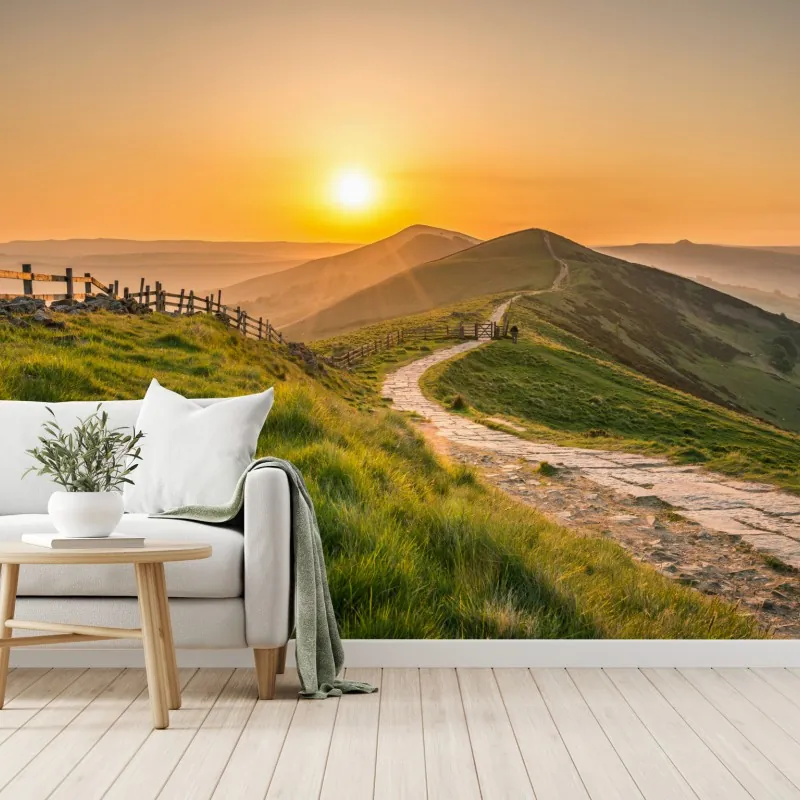 Fototapeta wschód słońca nad zielonymi pagórkami