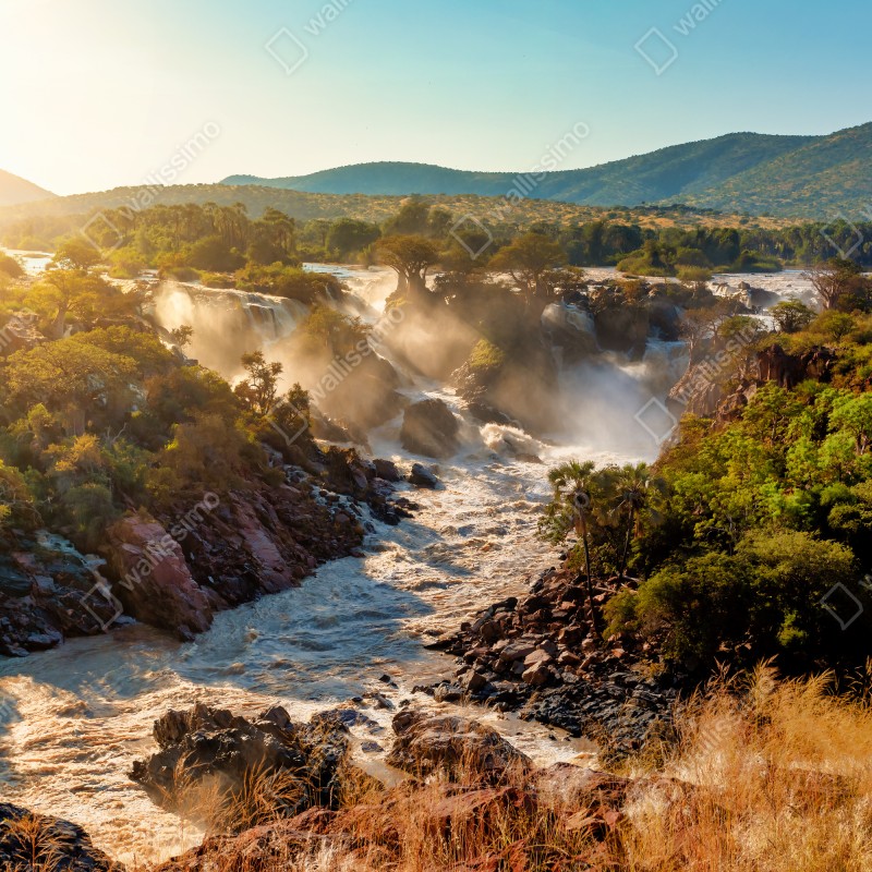 Naklejka repozycjonowalna wschód słońca nad Wodospadami Epupa – Wallissimo® Naklejka repozycjonowalna wschód słońca nad Wodospadami Epupa – Wallissimo®