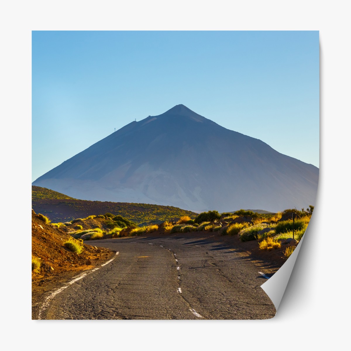 Repositionable sticker sunlit mountain road leading to a volcanic peak