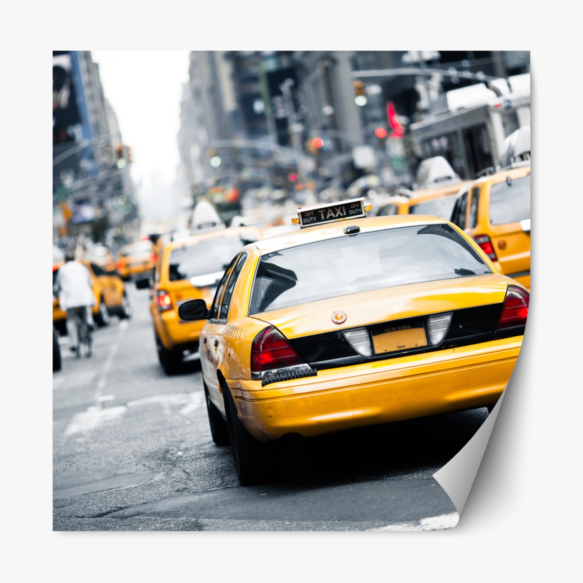 Repositionable sticker yellow taxis on a busy New York street