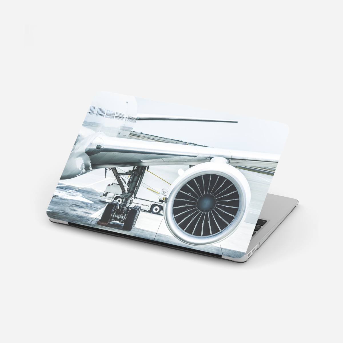 Laptop sticker close-up of jet engine at terminal
