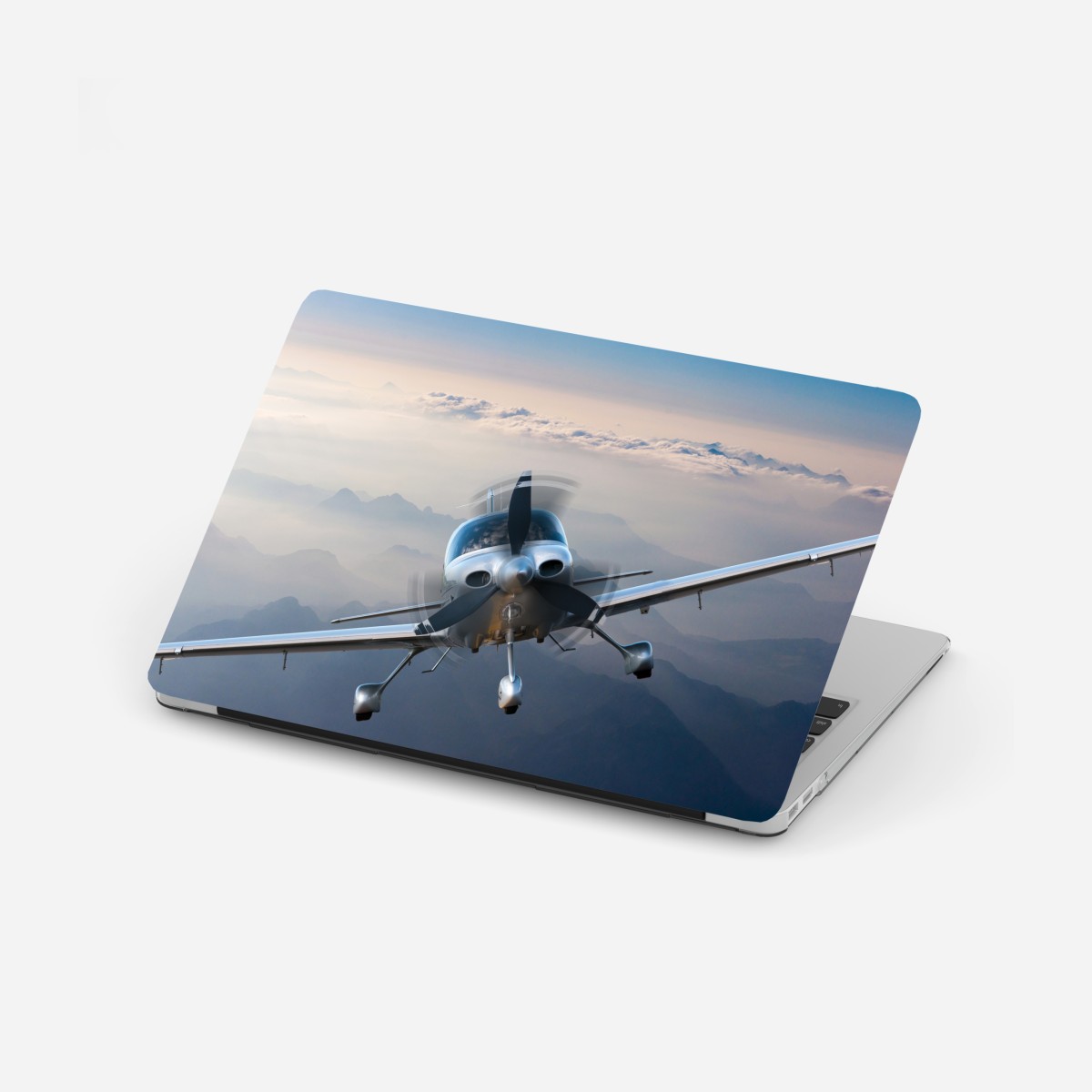 Laptop sticker silver propeller plane over misty mountains
