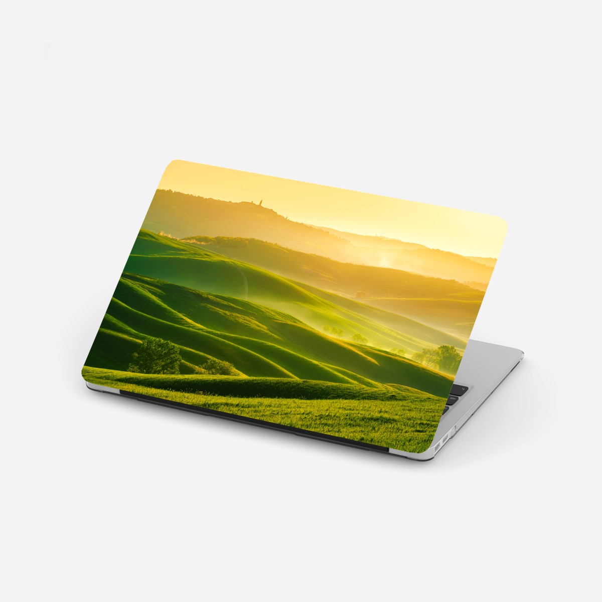 Laptop sticker golden sunrise over rolling green hills