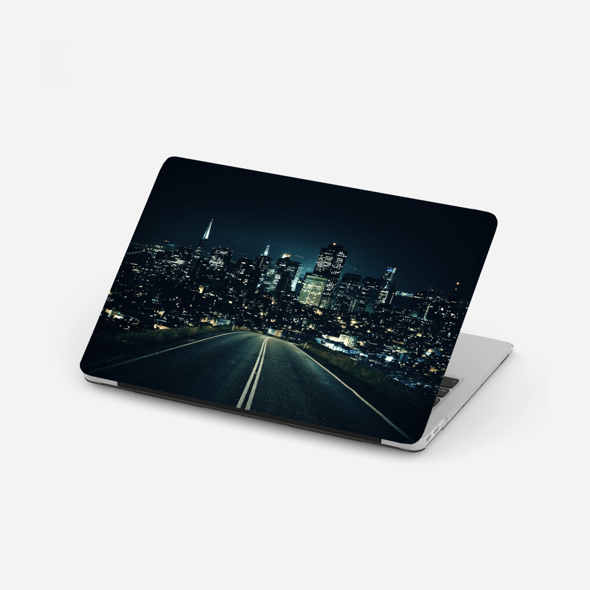 Laptop sticker road to illuminated city skyline at night