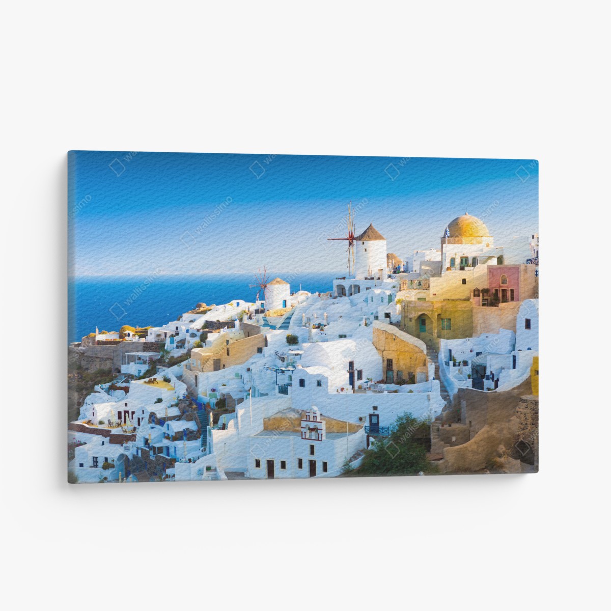 Canvas print sunlit Santorini village by the sea