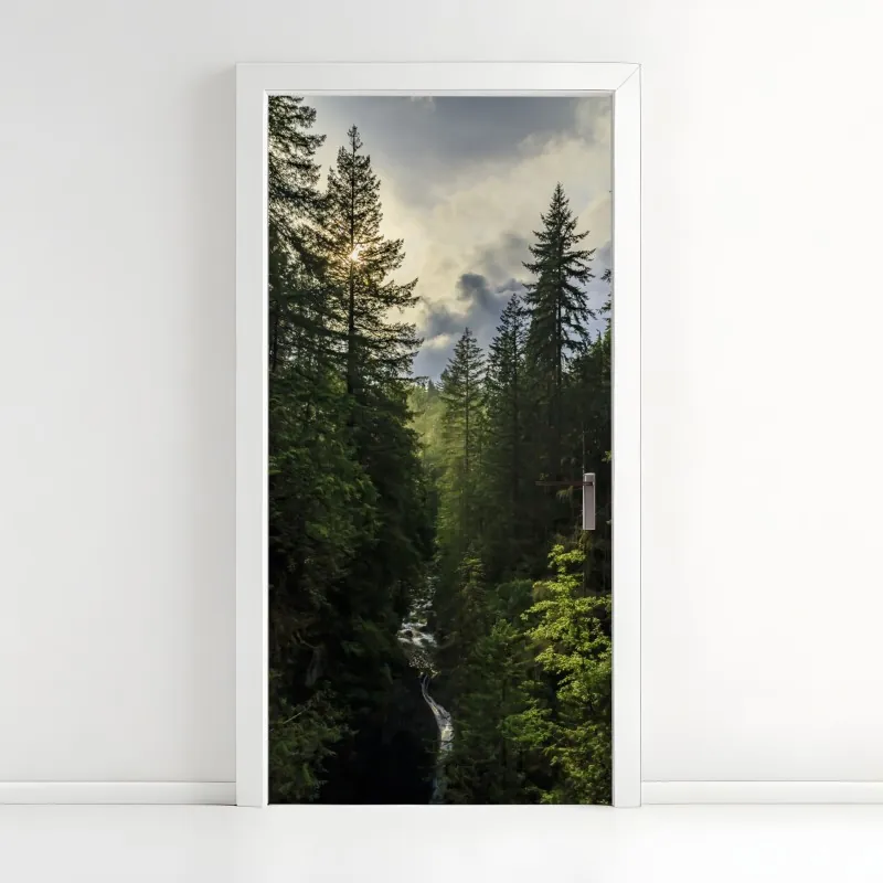 Naklejka na drzwi mglisty iglasty las z wodospadem