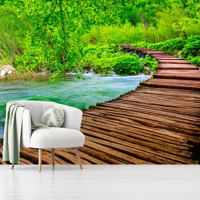 Wall mural serene green boardwalk over river